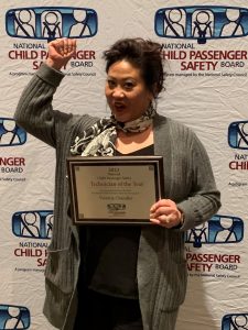 2023 Technician of the Year Victoria Chandler raises her right arm and pumps her fist after being recognized during an awards ceremony April 1 in Seattle.