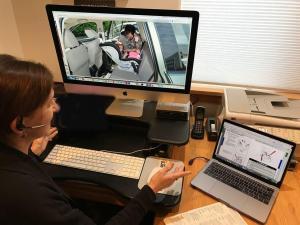 This is a photograph of a Child Passenger Safety Technician working with a caregiver during a virtual seat check.