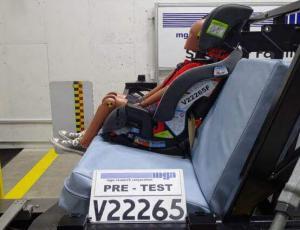 This is a photo of a crash dummy sitting in a car seat during a federal testing experiment.