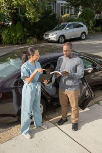 A child passenger safety technician is pictured here working with a parent during a car seat check event.