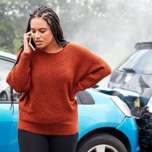 A young mother uses her phone to call for help after her vehicle was involved in a crash.