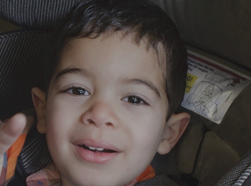 This image of a child sitting in his car seat used to promote Safe Kids' Ultimate Car Seat Guide.